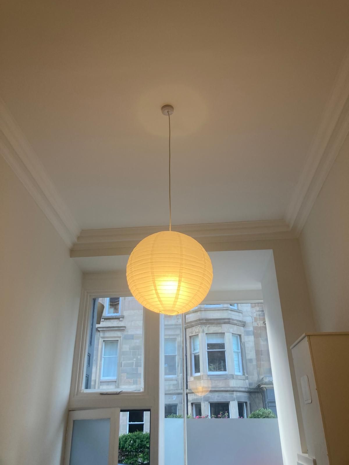 Paper globe pendant light in a bay-windowed Edinburgh flat